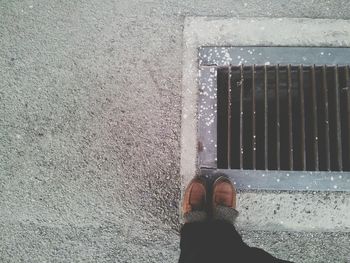 Low section of man standing on street