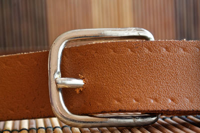 Close-up of belt on place mat