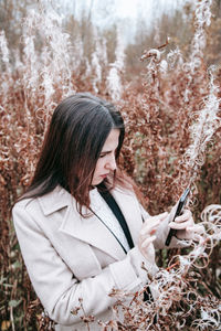 Side view of woman holding plants