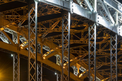 Low angle view of illuminated bridge at night