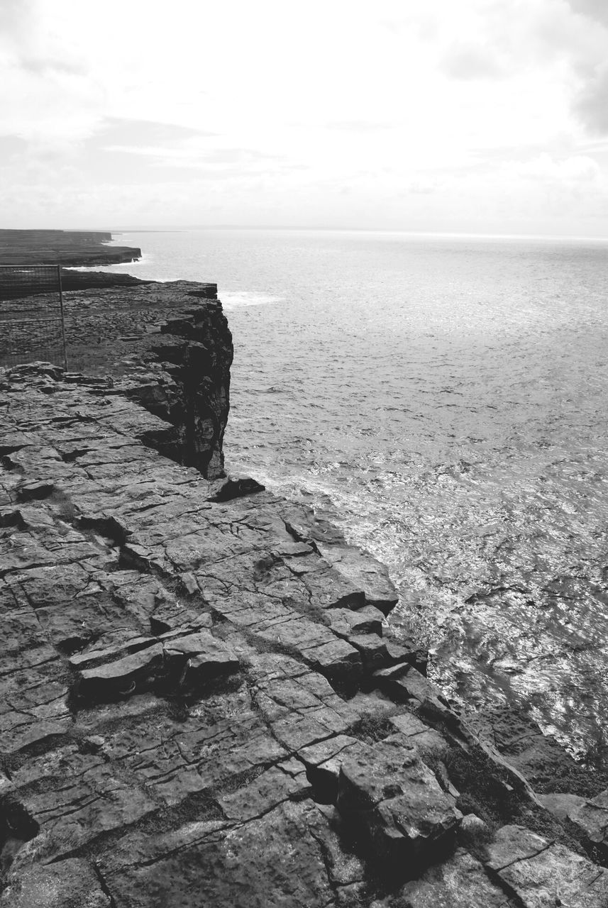 sea, horizon over water, water, sky, tranquil scene, tranquility, rock - object, scenics, beauty in nature, nature, cloud - sky, built structure, cloud, day, idyllic, rippled, outdoors, architecture, shore, rock