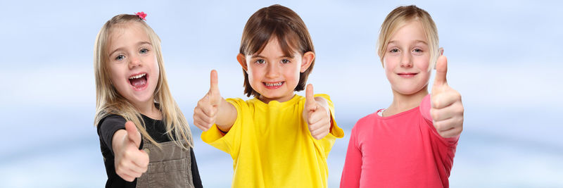 Portrait of happy girl standing against people