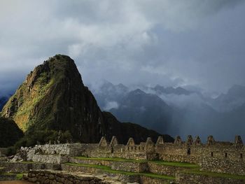 Scenic view of mountains against cloudy sky