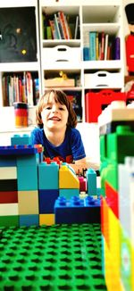 Portrait of boy sitting on book