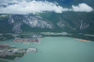 High angle view of lake and mountains against sky