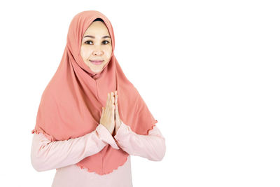 Portrait of a smiling young woman over white background