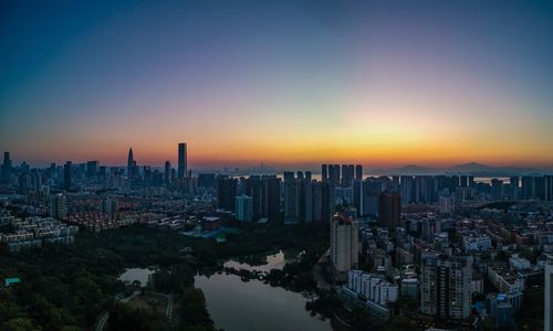 Aerial view of city buildings during sunset