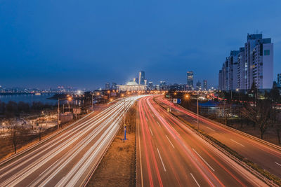 High angle view of light trails on road at night