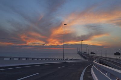 Highway against sky during sunset