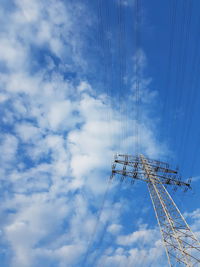 Low angle view of birds on electricity pylon against sky