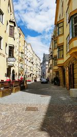 Street amidst buildings in city against sky