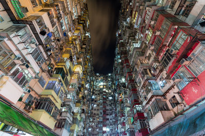 High angle view of illuminated buildings in city at night