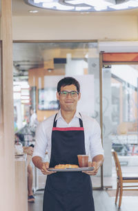 Portrait of a man standing with food