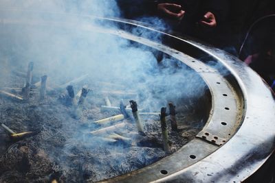 High angle view of smoke emitting from incense at temple