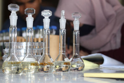 Close-up of glass bottles on table