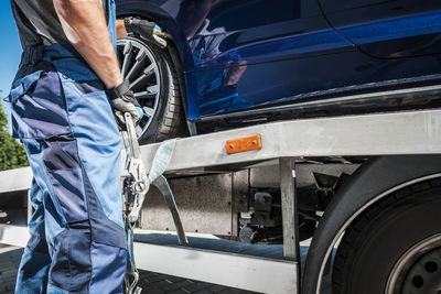 Midsection of man washing car