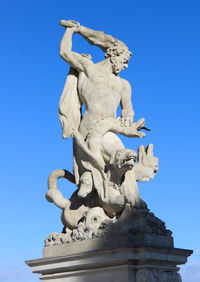 Low angle view of statue against clear blue sky