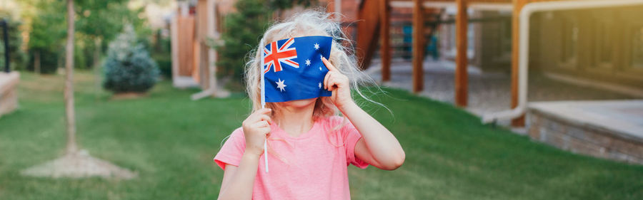 Full length of girl wearing mask against blurred background