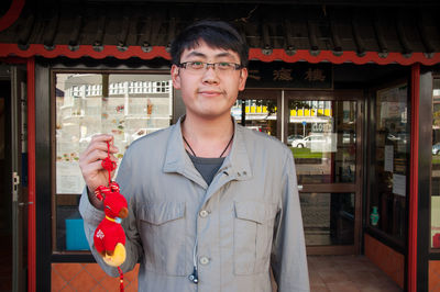 Portrait of man standing against built structure