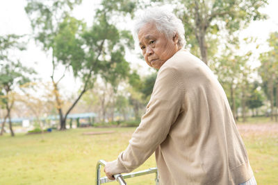 Side view of man standing in park