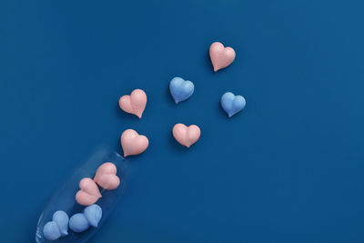 High angle view of human hand against blue background