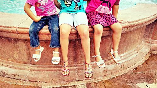 Low section of woman standing on tiled floor