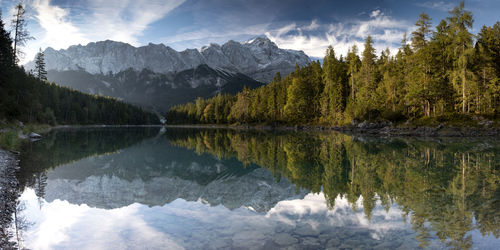 Scenic view of lake and mountains against sky