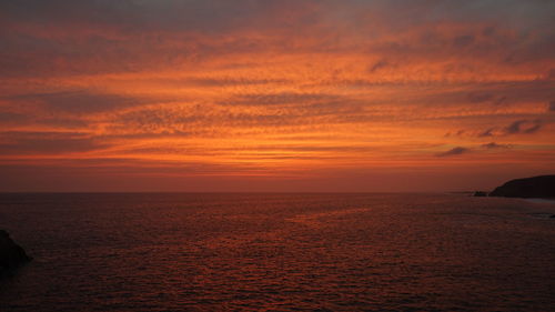 Scenic view of sea against orange sky