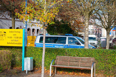 Information sign by trees in park during autumn