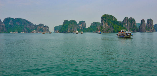 Boats in sea against sky