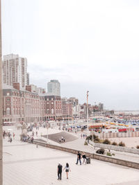 High angle view of people on street against buildings in city