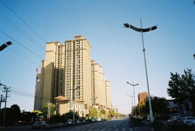 Low angle view of buildings against clear blue sky