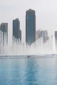 Panoramic view of sea and buildings against sky