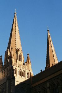 Low angle view of building against clear blue sky