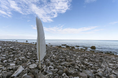 Rocks on beach against sky