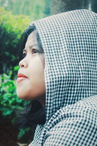 Close-up portrait of a young woman looking away