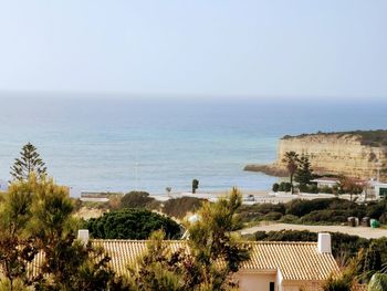 High angle view of buildings by sea against sky