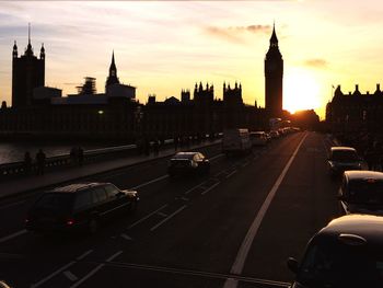 Traffic on road at sunset