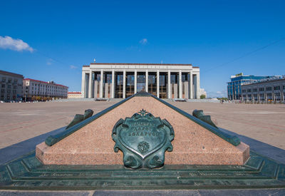 Statue of historic building against blue sky