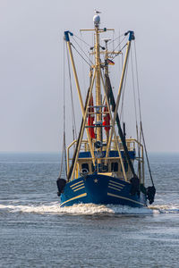 Sailboat on sea against clear sky