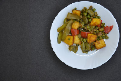 High angle view of chopped fruits in plate on table