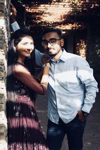 Portrait of young couple standing outdoors