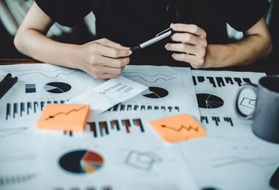 Midsection of man working on table