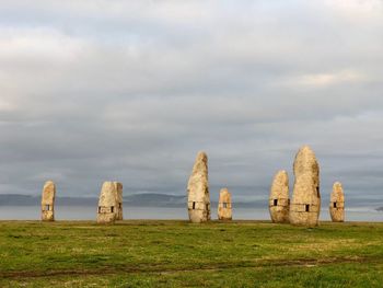 Built structure on field against sky