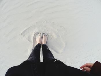 Low section of woman on sand