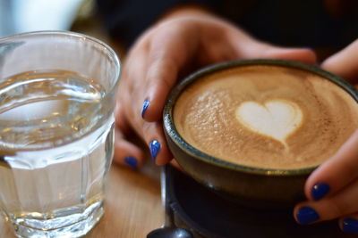 Cropped hand holding coffee