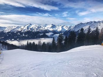 Scenic view of snow covered mountains against sky