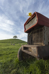 View of barn on field against sky