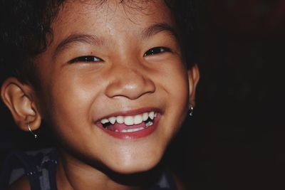 Close-up portrait of smiling baby girl at home