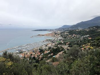 High angle view of townscape by sea against sky